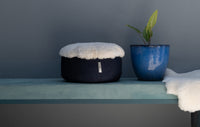 Sheepskin Meditation Cushion on a ledge , side view